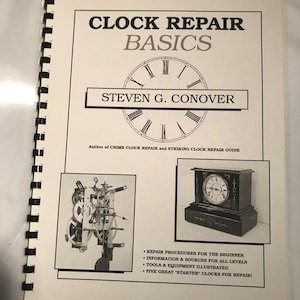 May include: An open book with a black spiral binding. The cover reads "CLOCK REPAIR BASICS" and "STEVEN G. CONOVER." Illustrations of clock mechanisms and a clock are included. Text lists repair procedures, information sources, and tools.