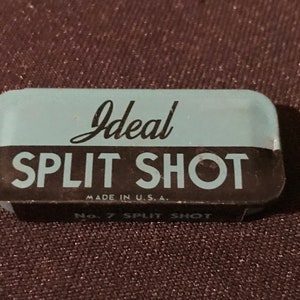 May include: A blue and black tin with the text "Ideal Split Shot" and "Made in U.S.A."  The tin also has the text "No. 7 Split Shot".