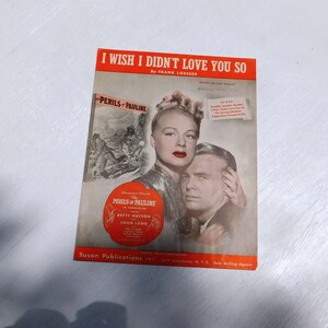 Puede incluir: Una portada de partitura musical vintage para la canción "I Wish I Didn't Love You So" de Frank Loesser. La portada presenta una foto en blanco y negro de una pareja de la película "The Perils of Pauline" protagonizada por Betty Hutton y John Lund.