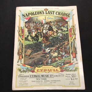 May include: Sheet music cover titled "Napoleon's Last Charge" by Edw. Ellis, arranged by E.T. Paull. The cover features a colorful illustration of a battle scene with soldiers on horseback. Published by E.T. Paull Music Co. in New York.