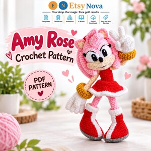 May include: A crochet doll of the character Amy Rose featuring pink hair, a red dress, white gloves, and red boots with white trim. The text reads Amy Rose Crochet Pattern and PDF Pattern. The doll is making a peace sign with one hand.
