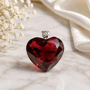 Deep Red Heart Crystal Pendant on Elegant Marble Background