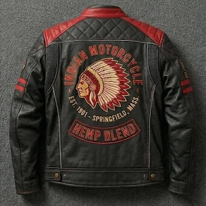May include: A black and red jacket featuring a large embroidered graphic on the back. The design includes a profile of a person in a headdress, the text "INDIAN MOTORCYCLE EST. 1901 SPRINGFIELD, MASS." and a banner reading "HEMP BLEND" in red.