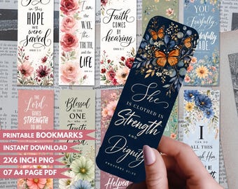 May include: A collection of rectangular bookmarks featuring floral illustrations and religious text. One prominent dark blue bookmark displays orange butterflies and the text She is clothed in strength and dignity Proverbs 31:25. Other designs include various flowers and verses.