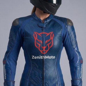May include: A blue leather motorcycle racing suit featuring a red panther head logo on the chest above the white text ZenithMoto. The suit has perforated leather panels, dark grey shoulder armour, and circuit board patterns on the sleeves.