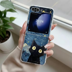 May include: A clear protective phone case for a foldable smartphone featuring a graphic print of a black cat with large yellow eyes against a dark blue starry night sky background. The case has cutouts for the camera lenses and the external display.