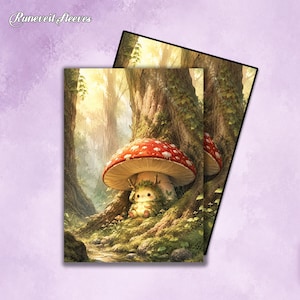 May include: Two rectangular card sleeves featuring the text Runeveil Sleeves. The illustration depicts a small, green, mossy creature sitting under a large red mushroom with white spots in a sunlit forest with tall trees and a small stream.