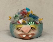 REALLY SMALL BOWL-Wheel thrown, hand altered & sculpted. Just a friendly face to hold a dieters portion of ice cream, Q Tips, or candy.