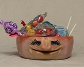 REALLY SMALL BOWL-Wheel thrown, hand altered & sculpted. Just a friendly face to hold a dieters portion of ice cream, Q Tips, or candy.