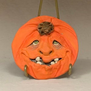 SAUCER Pumpkin. Wheel thrown, hand altered and sculpted ceramic saucer or wall hanging. A friendly face to enjoy for the holiday season. image 1