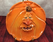 PUMPKIN PLATE -Wheel thrown, hand altered and sculpted ceramic plate or wall hanging. A friendly face to enjoy for the holiday season. PPL10