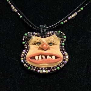 BEADED OGRE NECKLACE - This unique necklace is an original, one of a kind, hand sculpted necklace, made of stoneware clay and beads.