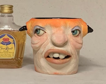SHOT GLASS - wheel thrown, hand altered and sculpted. A friendly face to enjoy your favorite beverage.