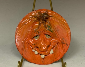 SAUCER- Pumpkin  Wheel thrown, hand altered and sculpted ceramic saucer or wall hanging. A friendly face to enjoy for the holiday season.