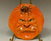 PUMPKIN SAUCER Wheel thrown, hand altered and sculpted ceramic saucer or wall hanging. A friendly face to enjoy for the holiday season.