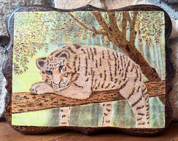 A one-of-a-kind hand-pyrographed white tiger portrait burned directly into wood — the kind of labor-intensive original art you genuinely can't just 'order off a shelf'.