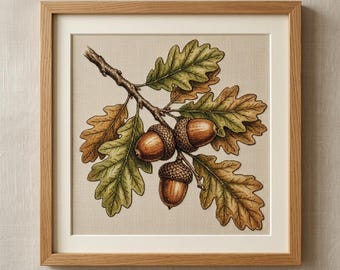 May include: A square framed cross-stitch embroidery featuring a detailed botanical illustration of an oak branch with three brown acorns and several green and golden-brown lobed oak leaves, set against a neutral beige fabric background.