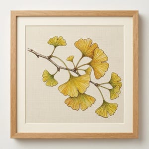 May include: A framed cross-stitch embroidery featuring a detailed botanical illustration of a ginkgo branch with fan-shaped yellow and green leaves. The artwork is set against a cream-colored fabric background and enclosed in a light wood frame.