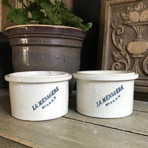 May include: Two white ceramic containers with blue lettering that reads "La Ménagère by S.G.D.G."