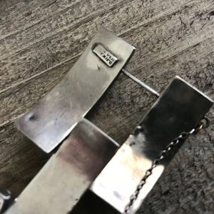 May include: Silver bracelet with a chain detail and a rectangular tag that reads "925 MEXICO".