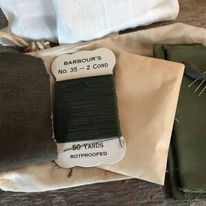 May include: A sewing kit with green fabric, thread, and needles. The thread is labeled "Barbour's No. 35 - 2 Cord 50 Yards Rotproofed".