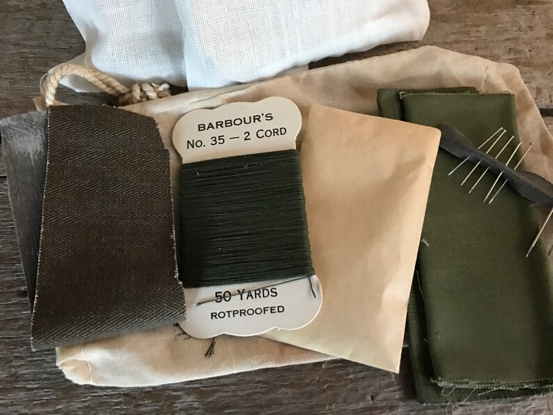 May include: A sewing kit with green fabric, thread, and needles. The thread is labeled "Barbour's No. 35 - 2 Cord 50 Yards Rotproofed".