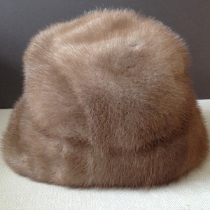 May include: A brown fur hat with a wide brim.