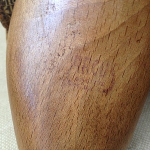 May include: A close-up of a wooden shoe stretcher with a red stamp that reads "ACCO 38".