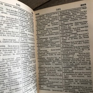 May include: A close-up of a dictionary page with the word "consumado" highlighted. The page is open to the letter "C" and includes definitions for words like "constipado", "constituci&oacute;n", "consumado", "consumici&oacute;n", "consumidor", "consumido", "consumir", "consumo", "consunci&oacute;n", "consuno", "contabilidad", "contacto", "contado", "contador", "contadur&iacute;a", "contagiar", "contagio", and "contagioso".