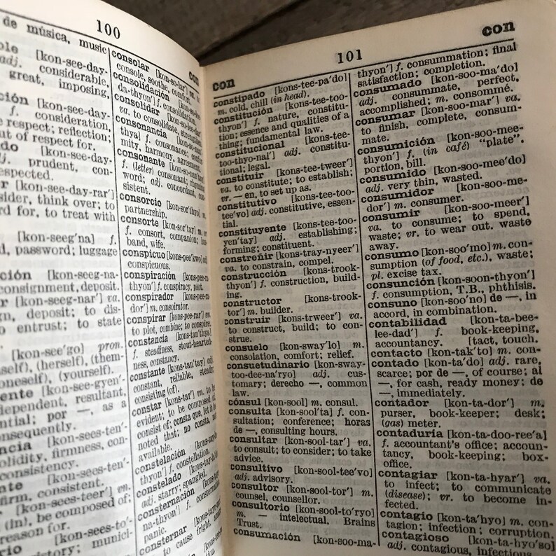 May include: A close-up of a dictionary page with the word "consumado" highlighted. The page is open to the letter "C" and includes definitions for words like "constipado", "constituci&oacute;n", "consumado", "consumici&oacute;n", "consumidor", "consumido", "consumir", "consumo", "consunci&oacute;n", "consuno", "contabilidad", "contacto", "contado", "contador", "contadur&iacute;a", "contagiar", "contagio", and "contagioso".