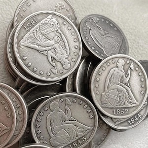 May include: A collection of silver-toned United States Seated Liberty coins featuring various dates including 1843, 1844, 1852, and 1867. Each coin displays a seated figure holding a pole with a liberty cap, surrounded by stars along the circular edge.