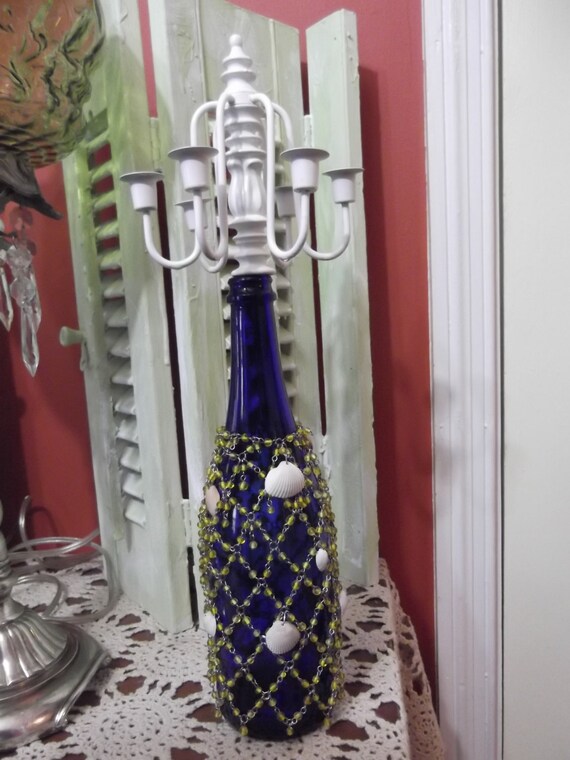 Items similar to Upcycled wine bottle candelabra, beaded and shell wine