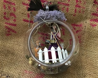 Garden witch with her crystals and herbs, ouija, tarot feathers, bottles of special potions