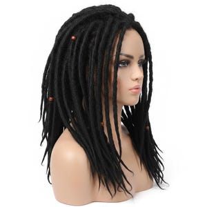 May include: A black wig featuring long, textured dreadlocks styled with small, round, brown wooden beads interspersed throughout the hair. The wig is displayed on a mannequin head, showcasing the uniform dark color and the layered length of the locks.