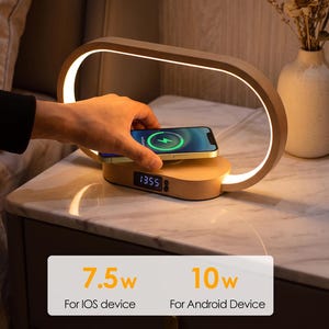 May include: A light wood wireless phone charging dock with an oval-shaped integrated LED lamp. The base features a digital clock display showing 13:55. Text reads: Wireless Phone Charging Dock, Please use 9V/2A adaptor, 7.5w For IOS device, 10w For Android Device.