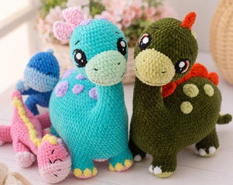 May include: A collection of four crocheted dinosaur toys. The group includes a large turquoise dinosaur with purple spots, a large olive green dinosaur with light green spots and a red crest, a small blue dinosaur, and a small pink dinosaur.
