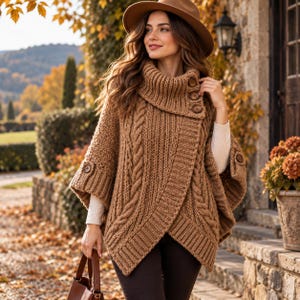 May include: A brown cable-knit poncho featuring a high cowl neck with three buttons, ribbed cuffs, and a wrap-style front. The garment is worn over a white long-sleeve shirt and dark pants, paired with a brown hat and a brown handbag.