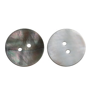 May include: Two round, two-hole, mother-of-pearl buttons. One button is black with iridescent swirls, the other is white.