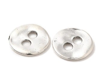 May include: Two silver-colored, round buttons with three holes each. The buttons have a slightly textured surface and a vintage appearance. These buttons are suitable for sewing projects and crafts.