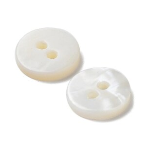May include: Two round, off-white buttons with two holes each. The buttons have a pearlescent sheen and a slightly rounded edge. The buttons are likely for sewing or crafting.
