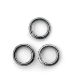 May include: Three silver jump rings, each with a circular shape and a slightly flattened profile.