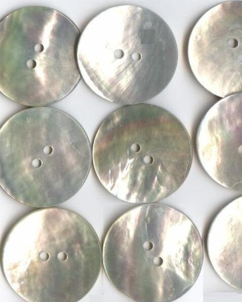 May include: Ten round, white mother of pearl buttons with two holes each.