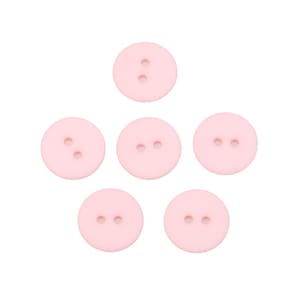 Pode incluir: Seis botões de plástico rosa com dois furos cada.