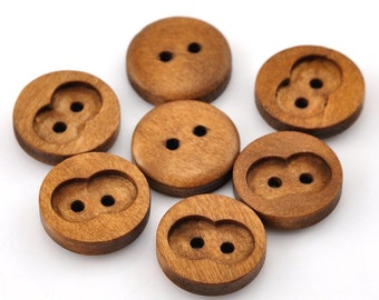 May include: A set of six wooden buttons with two holes each. The buttons are a light brown color and have a smooth, rounded surface.