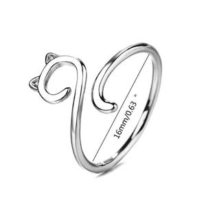 Könnte beinhalten: Silberner Katzenring mit einem gekräuselten Schwanz und Katzenohren. Der Ring hat einen Durchmesser von 16 mm/0,63 Zoll.