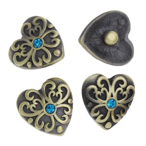 May include: Four antique gold heart-shaped buttons with ornate designs and blue rhinestone accents.