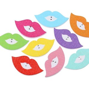 May include: Assortment of ten wooden lips-shaped buttons in various colors, including red, pink, orange, yellow, green, blue, and purple. Each button has a white center with two silver-colored embellishments.