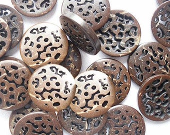 May include: A collection of round, brown wooden buttons with intricate cut-out designs. The buttons have a natural, organic look and varying shades of brown. These decorative buttons are ideal for sewing, crafting, and adding a unique touch to garments or accessories.