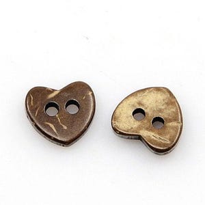 May include: Two brown heart-shaped coconut shell buttons with two holes each.