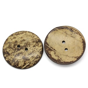 May include: Two brown coconut shell buttons with two holes each.